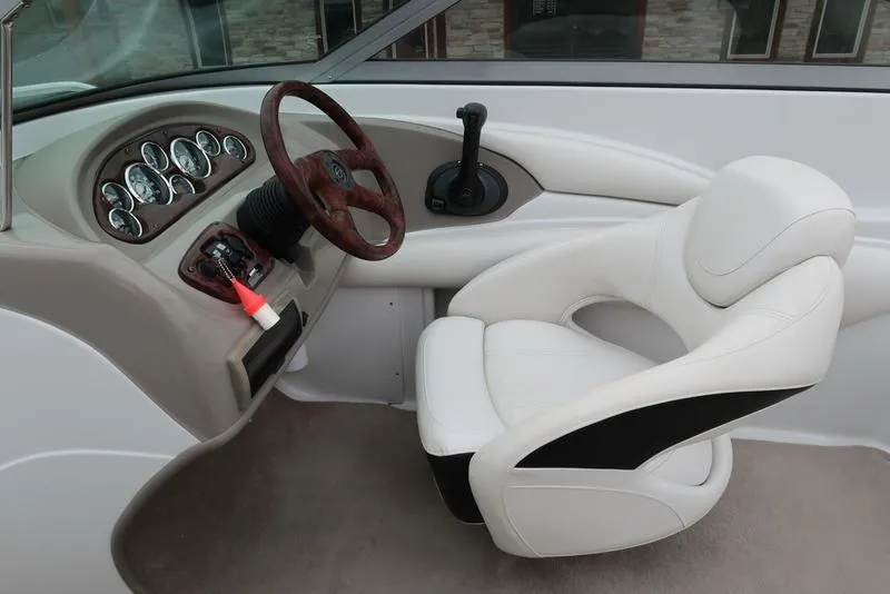 Slide: The Image of Interior of 2008 Crownline 21LS boat with steering wheel and white captain's chair. - 12