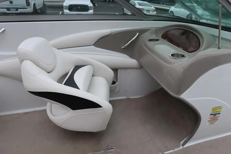 Slide: The Image of 2008 Crownline 21LS boat interior with white seating and dashboard. - 15