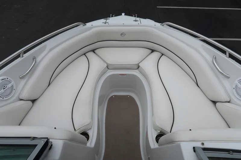 Slide: The Image of 2008 Crownline 21LS boat interior with white cushioned seating and speakers. - 16