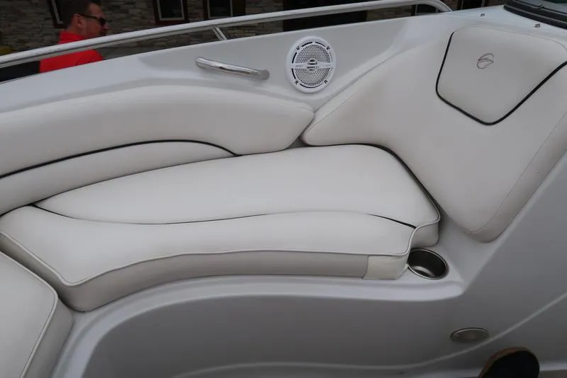 Slide: The Image of 2008 Crownline 21LS boat interior with white cushioned seating and speaker. - 17