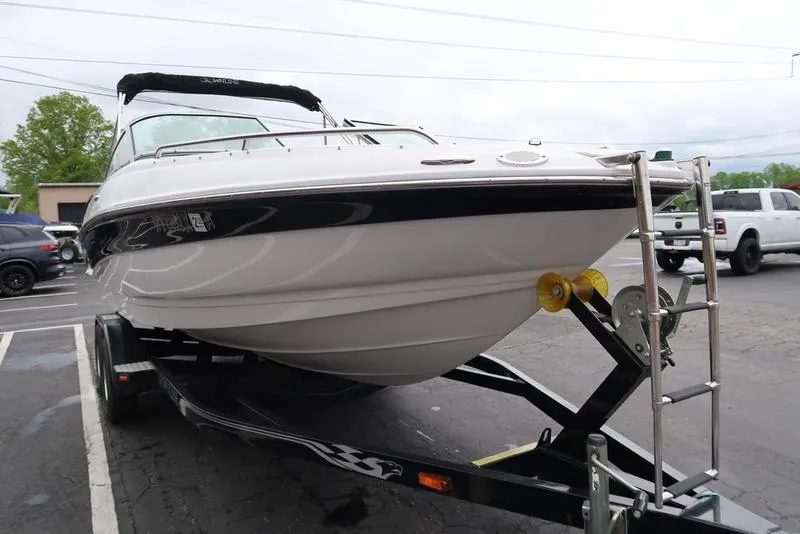 Slide: The Image of 2008 Crownline 21LS boat on trailer in parking lot. - 3