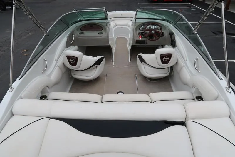 Slide: The Image of 2008 Crownline 21LS boat interior with white seating and dashboard view. - 8