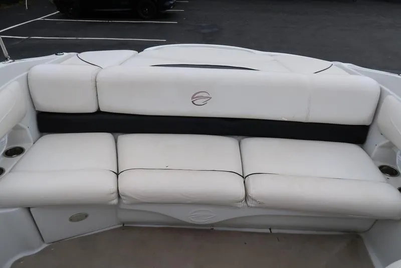 Slide: The Image of White seating area on 2008 Crownline 21LS boat, featuring cushioned seats and cup holders. - 9