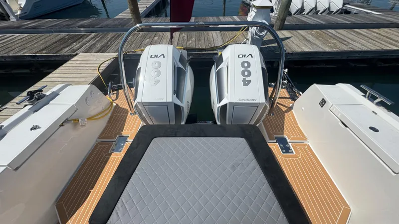 Slide: The Image of 2025 Nimbus T11 boat with twin 400 horsepower outboard engines at dock. - 14