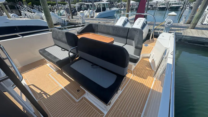 Slide: The Image of Luxury Nimbus T11 2025 boat with spacious seating and elegant deck design at marina. - 19