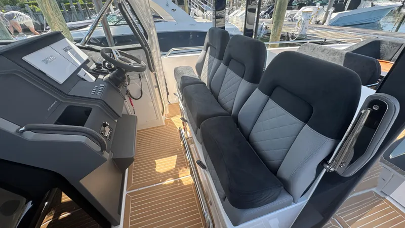 Slide: The Image of Interior of 2025 Nimbus T11 boat with modern seating and control panel. - 25