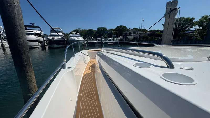 Slide: The Image of 2025 Nimbus T11 boat docked in a marina under clear blue skies. - 28