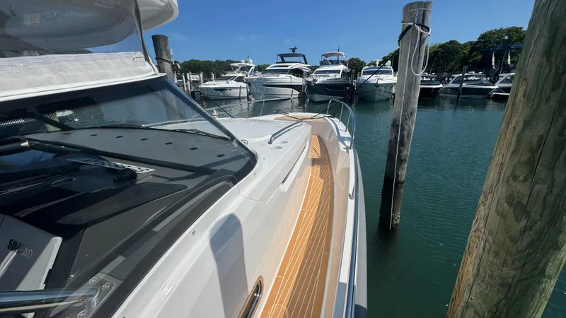 Slide: The Image of Nimbus T11 2025 yacht docked at marina with other boats in background. - 30