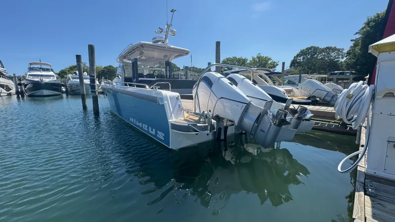 Slide: The Image of 2025 Nimbus T11 boat docked in a marina under clear blue skies. - 5