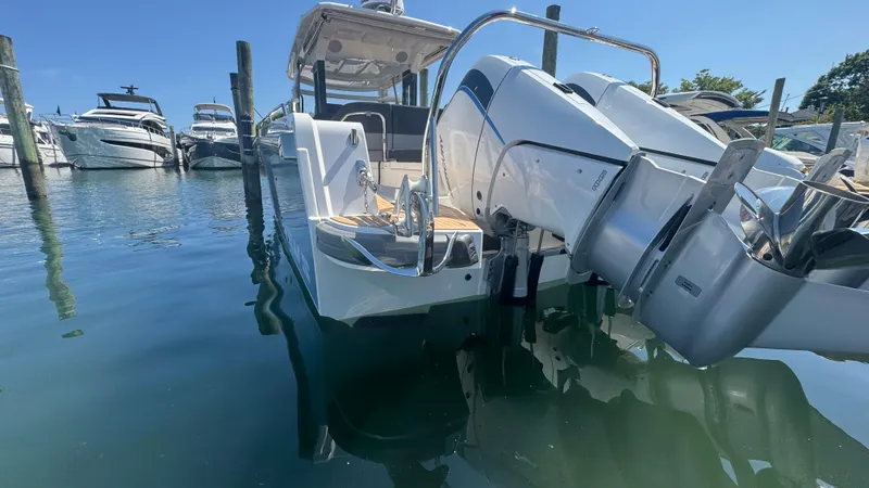 Slide: The Image of Nimbus T11 2025 boat docked in marina, featuring sleek design and powerful outboard engine. - 6