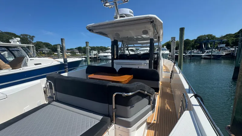 Slide: The Image of Luxurious 2025 Nimbus T11 boat docked, featuring spacious seating and sleek design. - 10