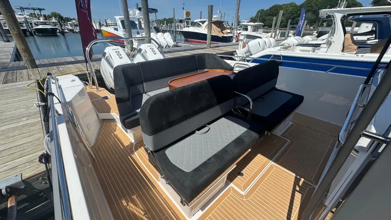 Slide: The Image of Luxurious 2025 Nimbus T11 boat with sleek seating and powerful engines at a marina. - 18