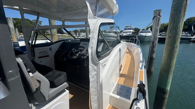 Slide: The Image of 2025 Nimbus T11 boat docked, showcasing sleek design and modern interior. - 29