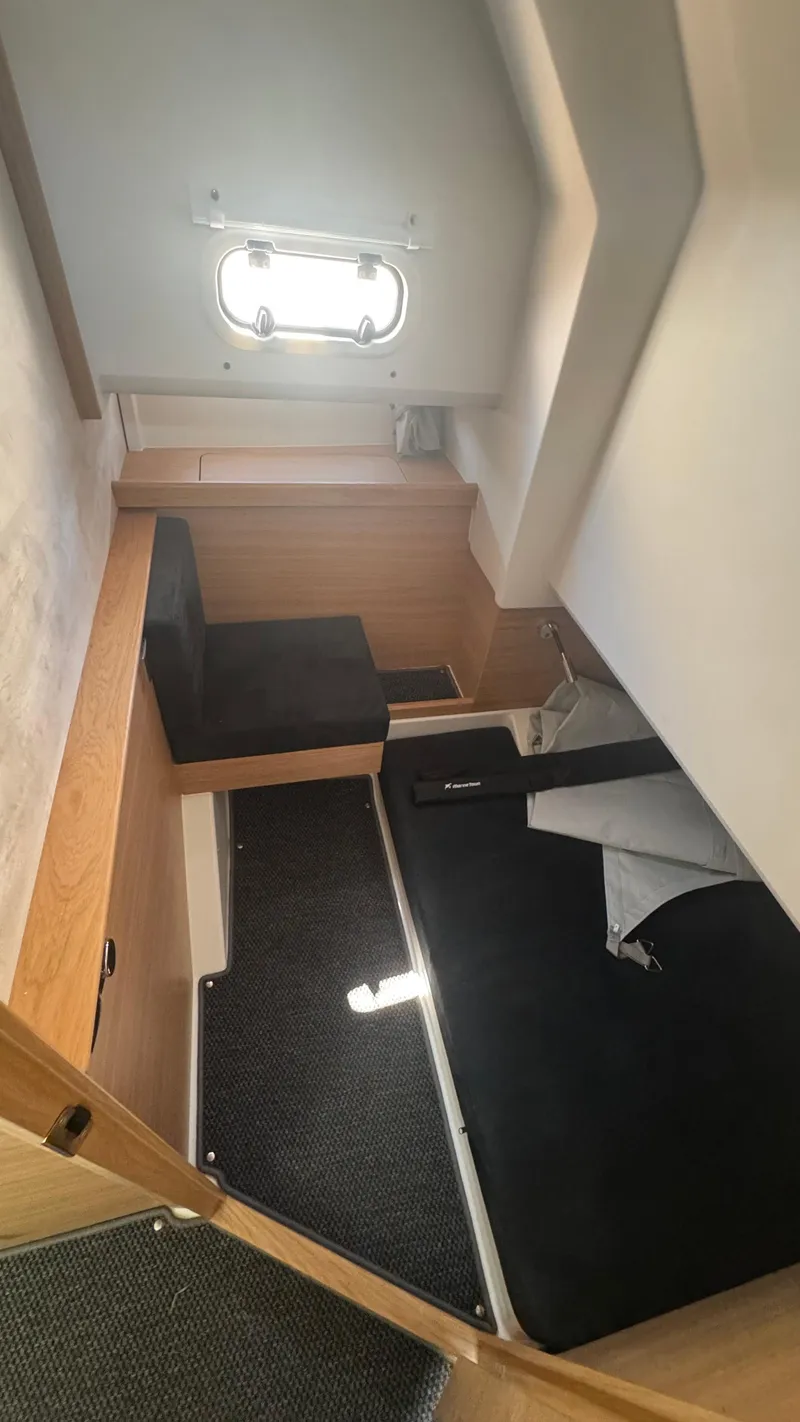 Slide: The Image of Cozy cabin interior of 2025 Nimbus T11 boat with seating and window. - 36