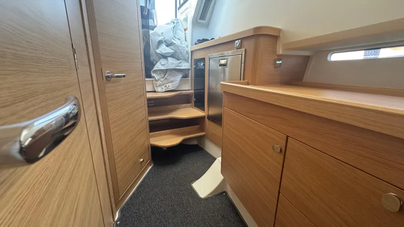Slide: The Image of Interior of 2025 Nimbus T11 boat with wooden cabinetry and compact stairs. - 38