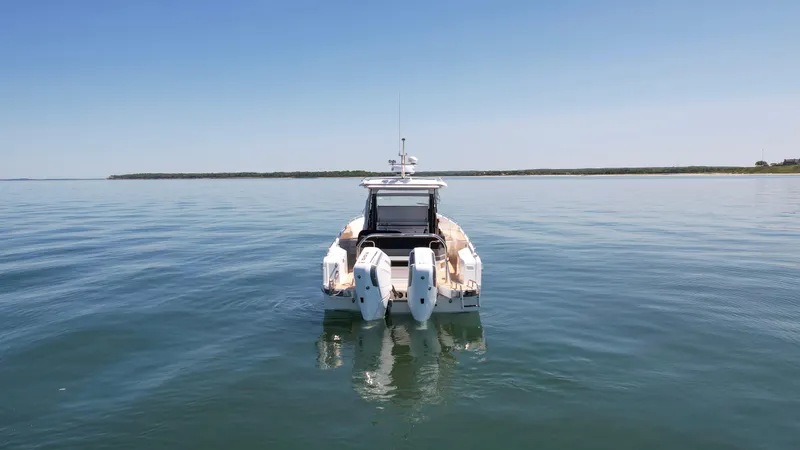 Slide: The Image of 2025 Nimbus T11 boat on calm water, rear view with clear sky. - 4