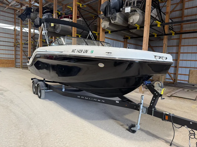 Slide: The Image of 2021 Bayliner DX2250 boat on trailer in storage facility. - 1