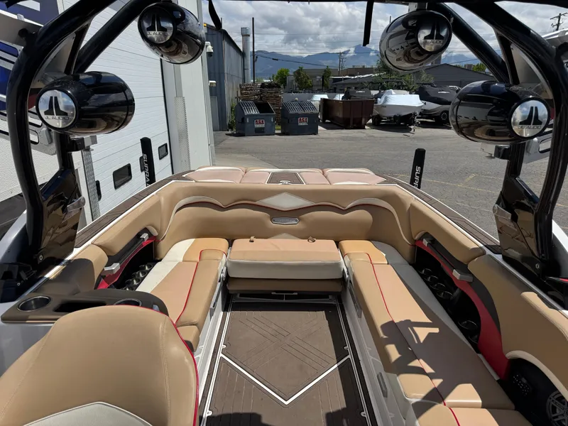 Slide: The Image of 2017 Supra SE 550 boat interior with beige seating and advanced audio system. - 1