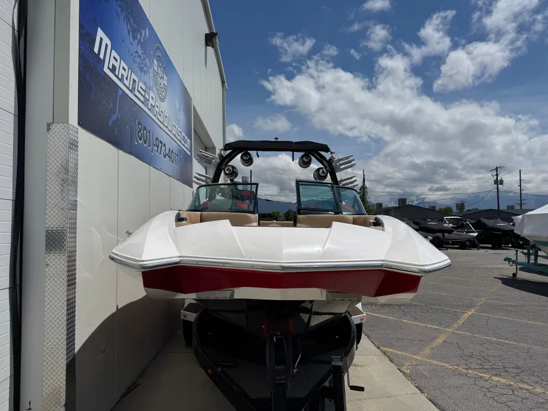 Slide: The Image of 2017 Supra SE 550 boat parked outside a marine dealership under a cloudy sky. - 4