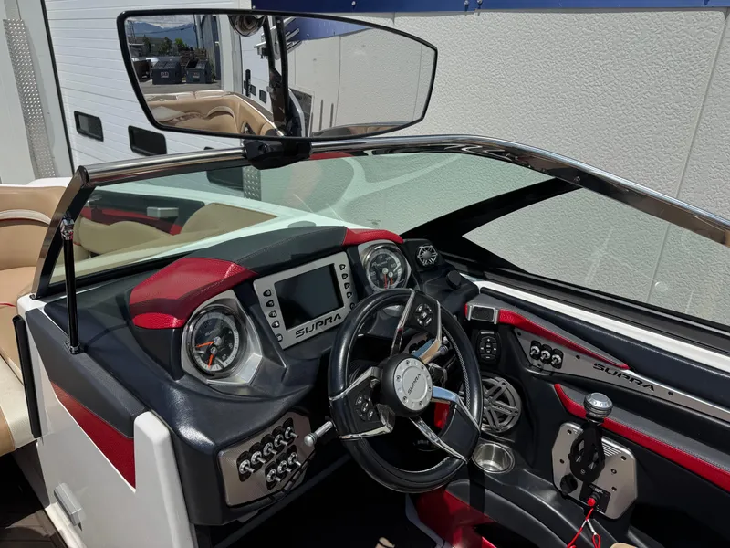 Slide: The Image of 2017 Supra SE 550 boat dashboard with steering wheel, gauges, and control panel. - 6