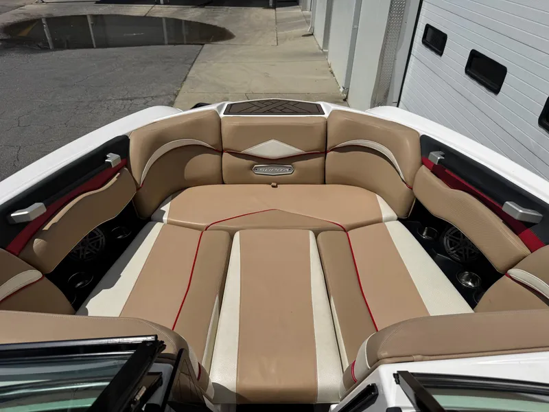 Slide: The Image of 2017 Supra SE 550 boat interior with tan and red seating. - 8