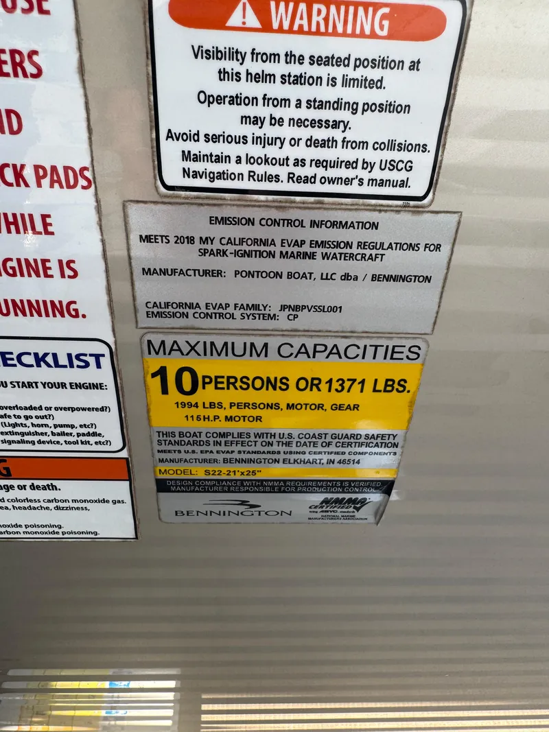 Slide: The Image of Warning and capacity labels on a 2018 Bennington 22 SLX pontoon boat. - 6