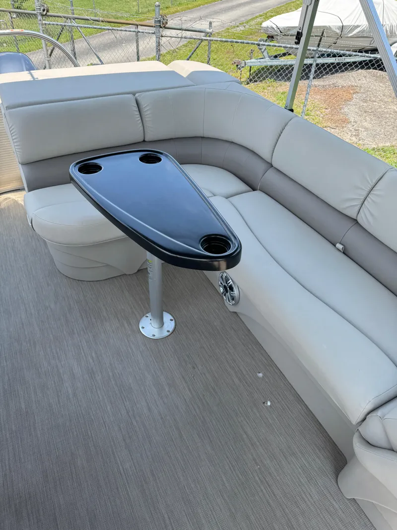 Slide: The Image of 2018 Bennington 22 SLX pontoon boat interior with gray seating and black table. - 7