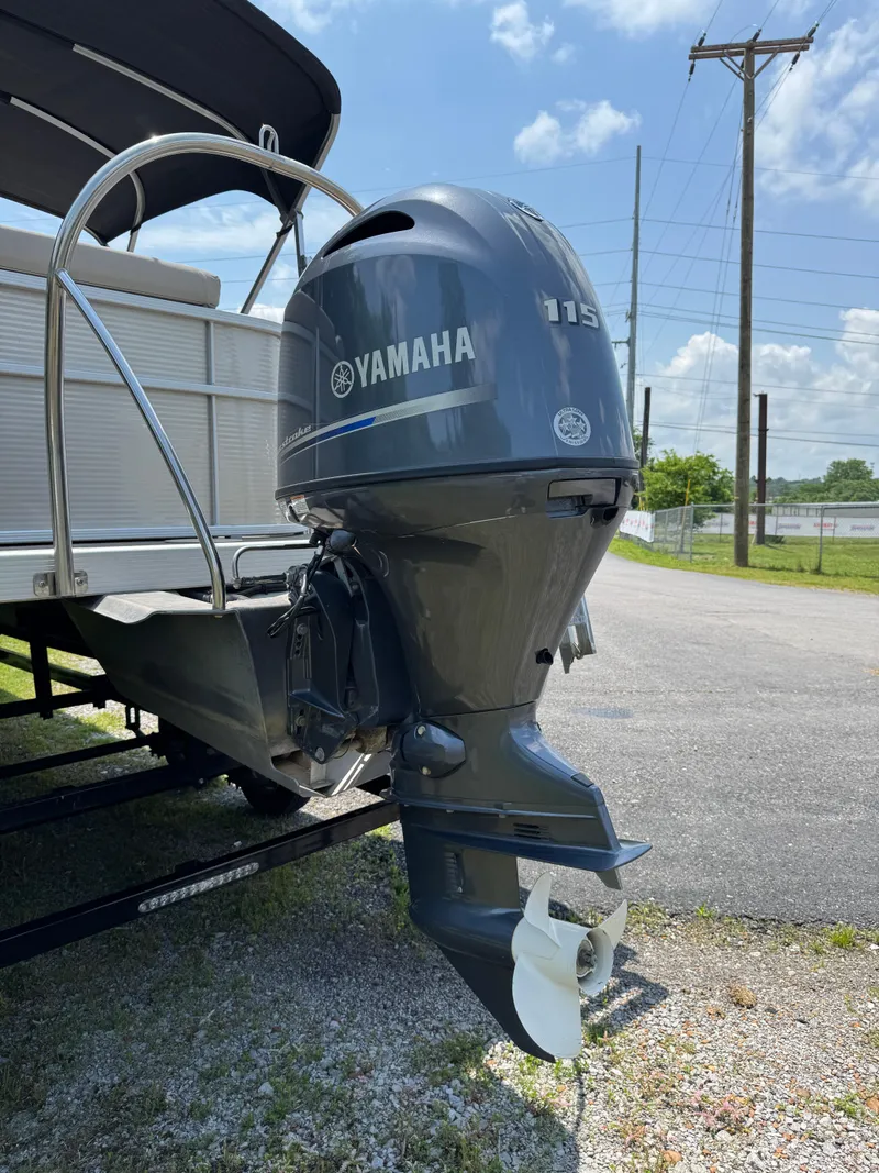 Slide: The Image of 2018 Bennington 22 SLX with Yamaha outboard motor, parked on a sunny day. - 9