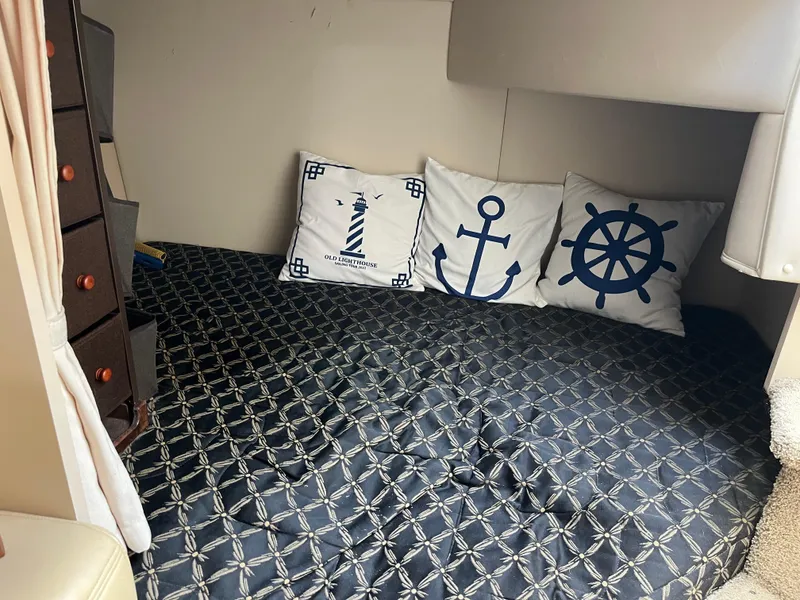 Slide: The Image of Interior cabin of 2001 Cruisers Yachts 2870 Express with nautical-themed pillows. - 20