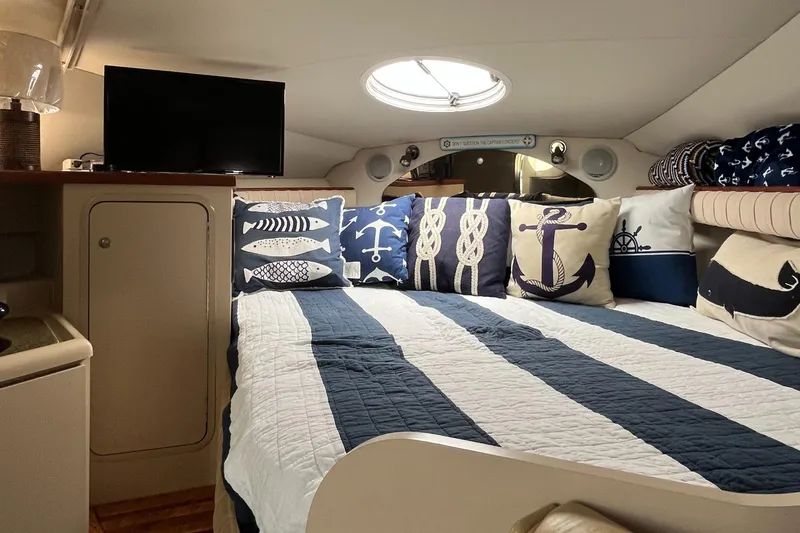 Slide: The Image of Cozy cabin interior of 2001 Cruisers Yachts 2870 Express with nautical-themed decor. - 29