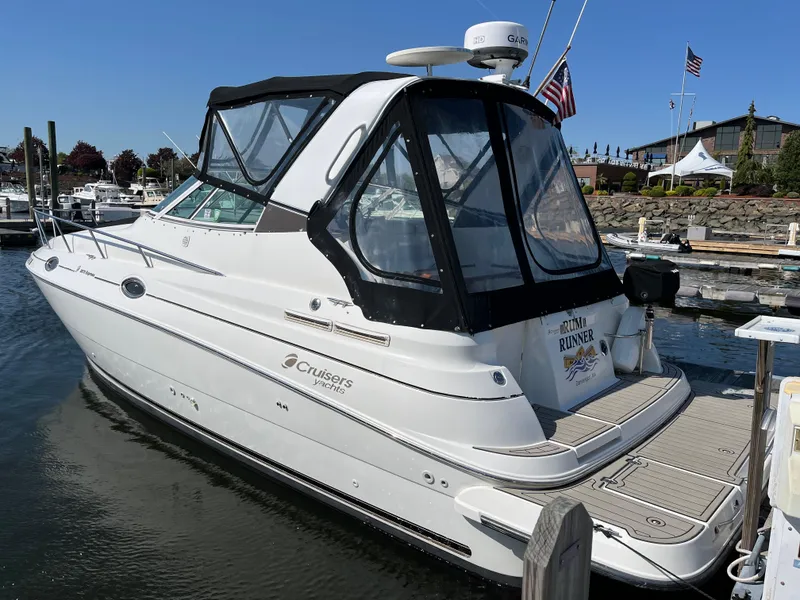 Slide: The Image of 2001 Cruisers Yachts 2870 Express docked at marina, featuring sleek design and spacious cabin. - 3