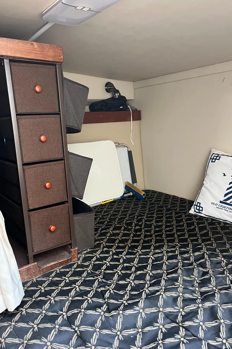 Slide: The Image of Interior cabin of 2001 Cruisers Yachts 2870 Express with storage and patterned bedding. - 34