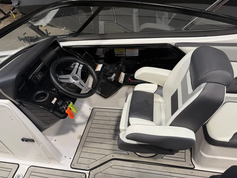 Slide: The Image of 2020 Yamaha Boats 212 cockpit with steering wheel and captain's chair, featuring modern design. - 4