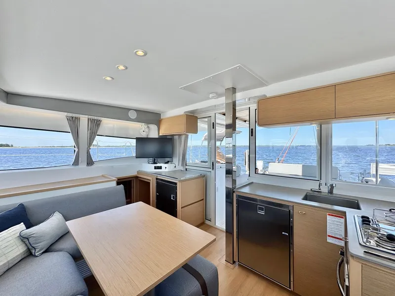 Slide: The Image of Modern interior of 2023 Excess 12 yacht with kitchen and seating area, overlooking the ocean. - 10