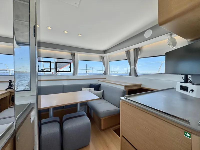 Slide: The Image of Modern interior of 2023 Excess 12 catamaran with panoramic windows and sleek furnishings. - 11