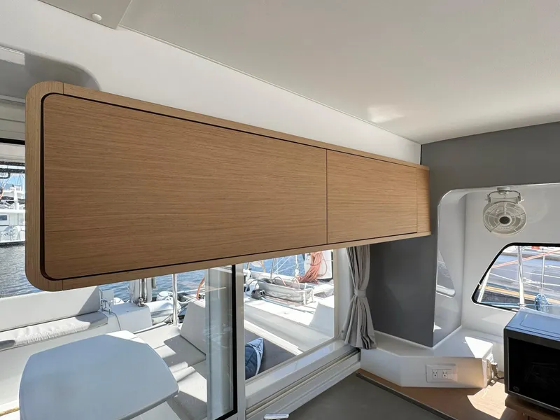 Slide: The Image of Interior of 2023 Excess 12 yacht with wooden cabinetry and large windows. - 13