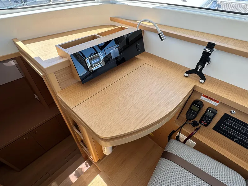 Slide: The Image of Modern navigation station in 2023 Excess 12 yacht with sleek wood finish and advanced controls. - 16