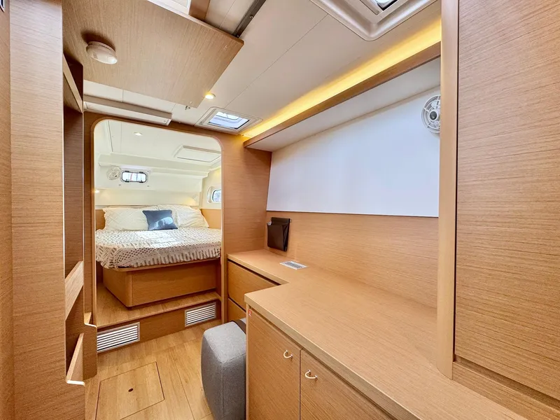 Slide: The Image of Interior of 2023 Excess 12 yacht featuring a cozy bedroom and modern wooden furnishings. - 19