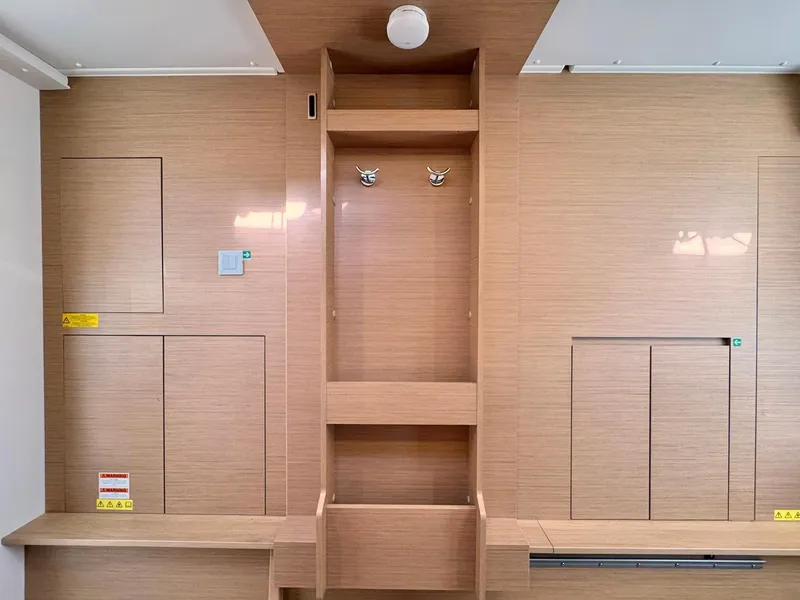 Slide: The Image of Interior of 2023 Excess 12 yacht with wooden paneling and storage compartments. - 27