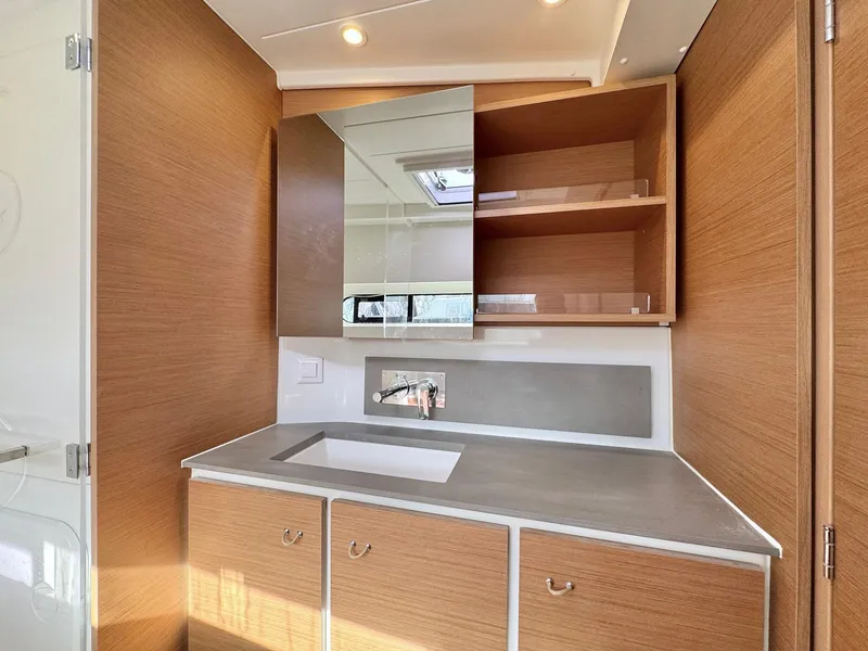 Slide: The Image of Modern bathroom vanity in 2023 Excess 12 yacht with wood cabinets and mirror. - 30