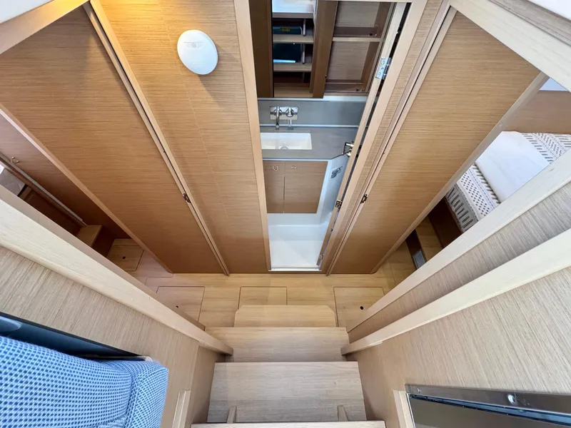 Slide: The Image of Interior of 2023 Excess 12 yacht, featuring wooden cabinetry and compact bathroom. - 37