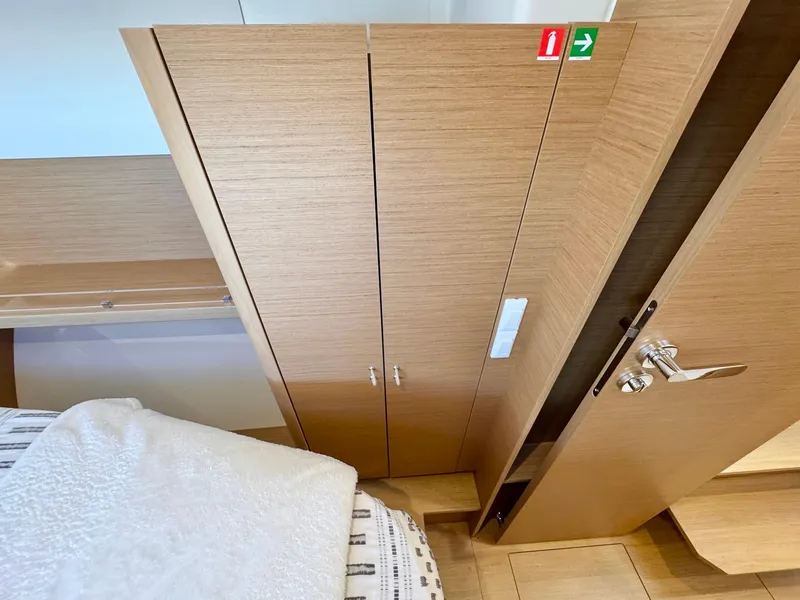 Slide: The Image of Wooden interior of 2023 Excess 12 yacht cabin with closet and bed. - 42