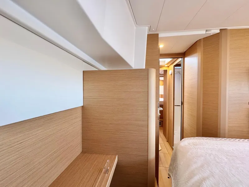 Slide: The Image of Interior of 2023 Excess 12 yacht, featuring modern wood paneling and cozy cabin space. - 43