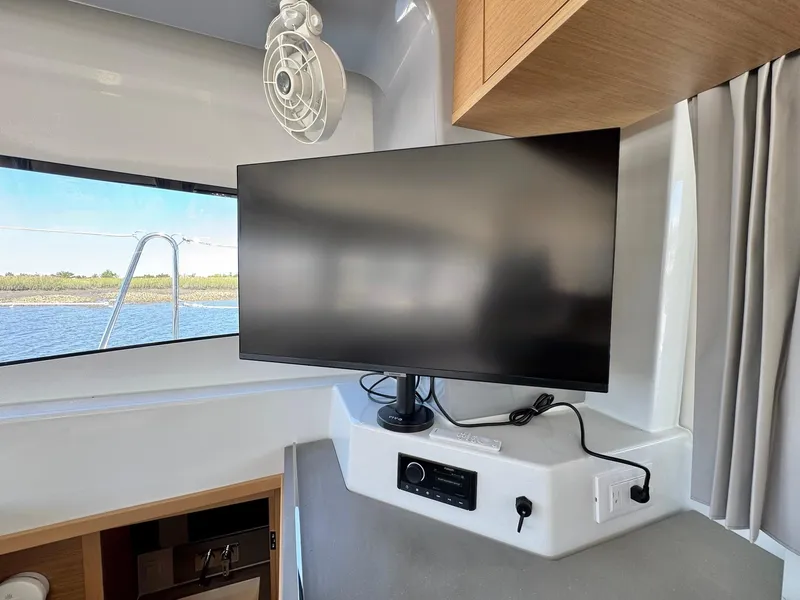 Slide: The Image of Interior of 2023 Excess 12 yacht with mounted TV and window view. - 9