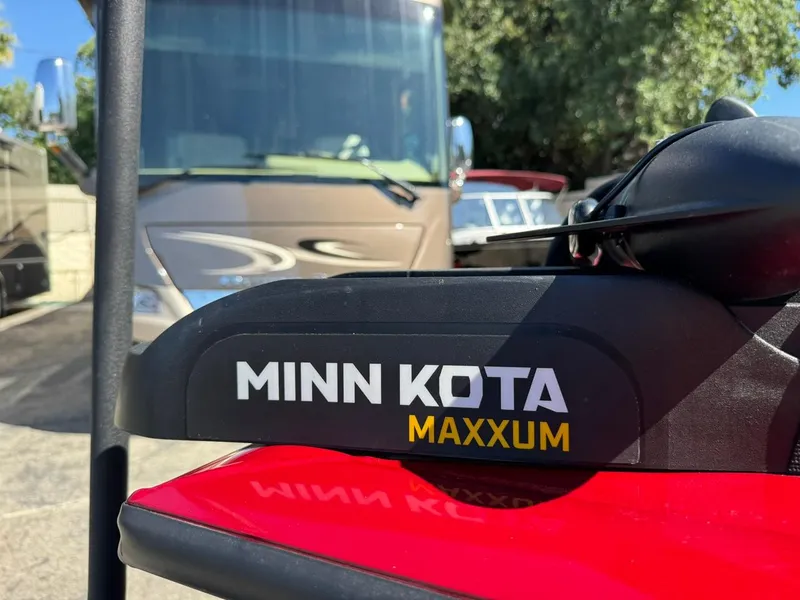 Slide: The Image of Minn Kota Maxxum motor on 2022 Tracker PRO TEAM 175 TWX boat, parked near RV. - 10