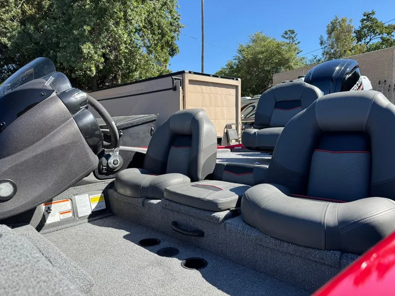 Slide: The Image of 2022 Tracker PRO TEAM 175 TWX boat interior with gray seating and steering console. - 12