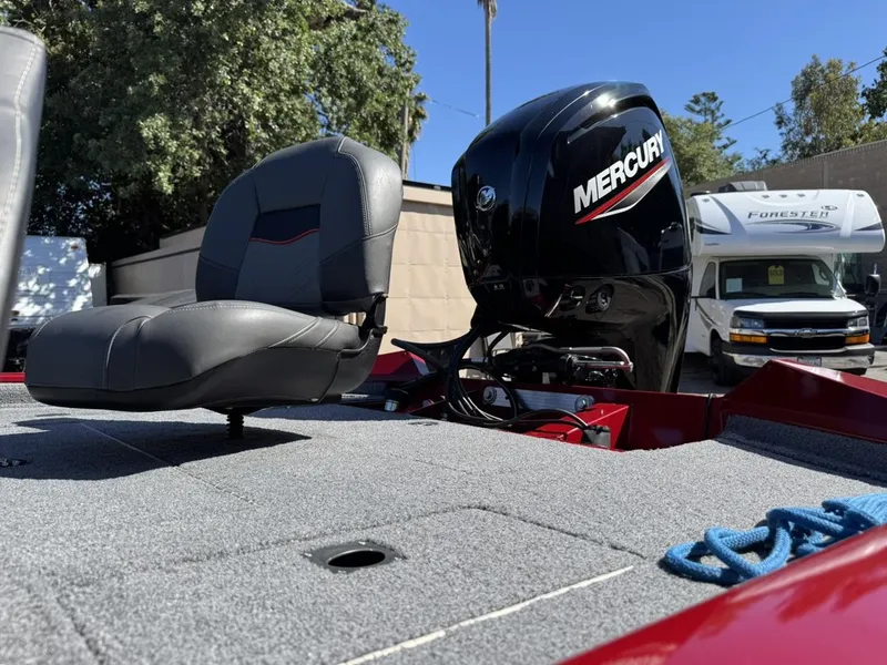 Slide: The Image of 2022 Tracker PRO TEAM 175 TWX boat with Mercury engine and seating, outdoors. - 13