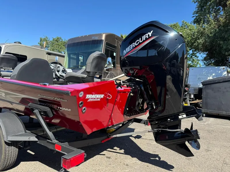 Slide: The Image of 2022 Tracker PRO TEAM 175 TWX boat with Mercury outboard motor, parked outdoors. - 19