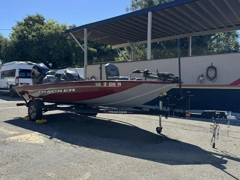 Slide: The Image of 2022 Tracker PRO TEAM 175 TWX boat on trailer in parking lot. - 2