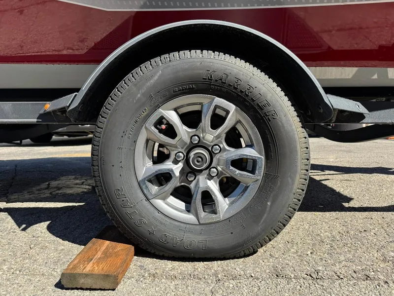 Slide: The Image of 2022 Tracker PRO TEAM 175 TWX trailer wheel with tire on pavement. - 22